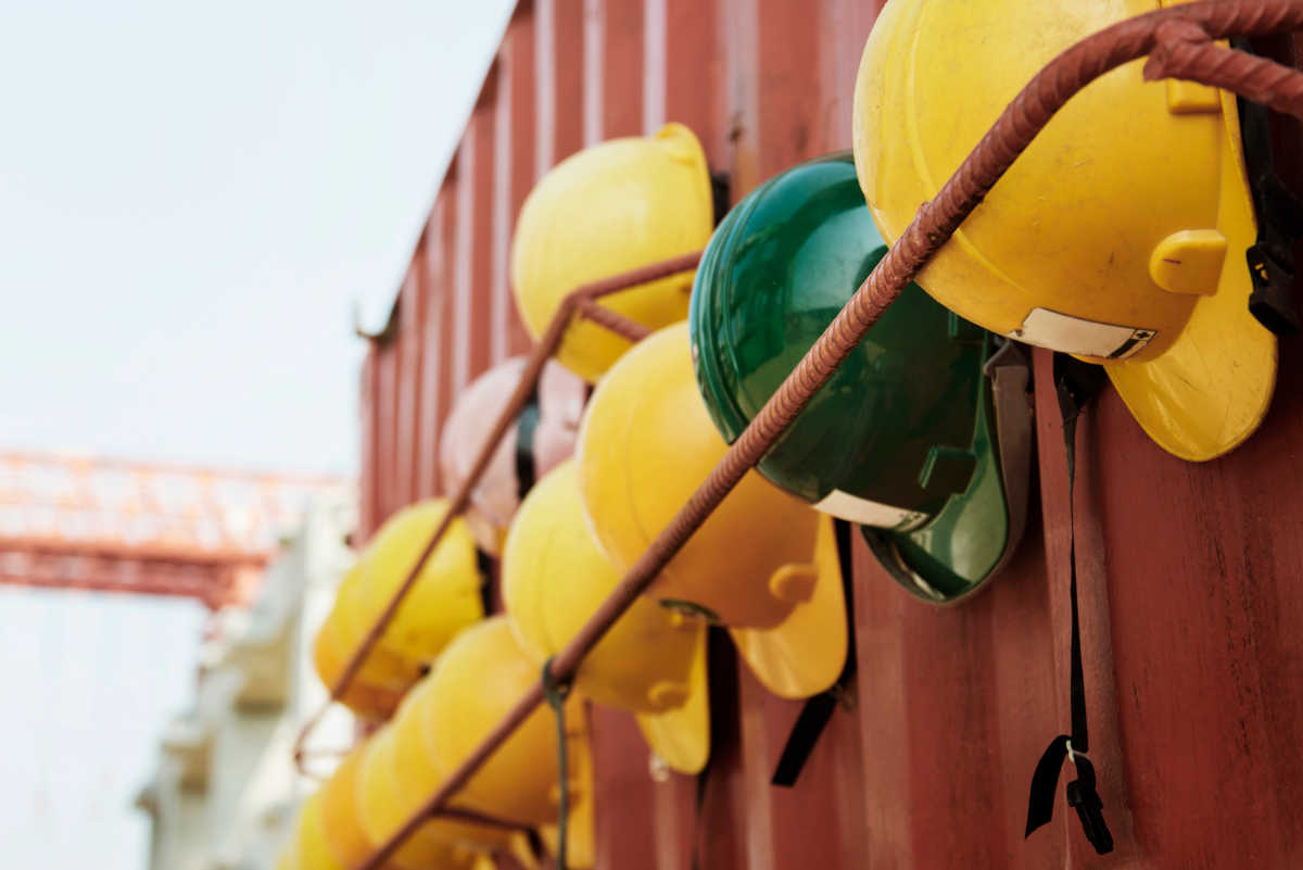 Construction hard hats hanging on a shipping container